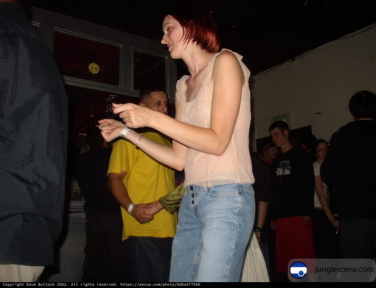 Woman with Red Hair Dancing in a Crowded Club