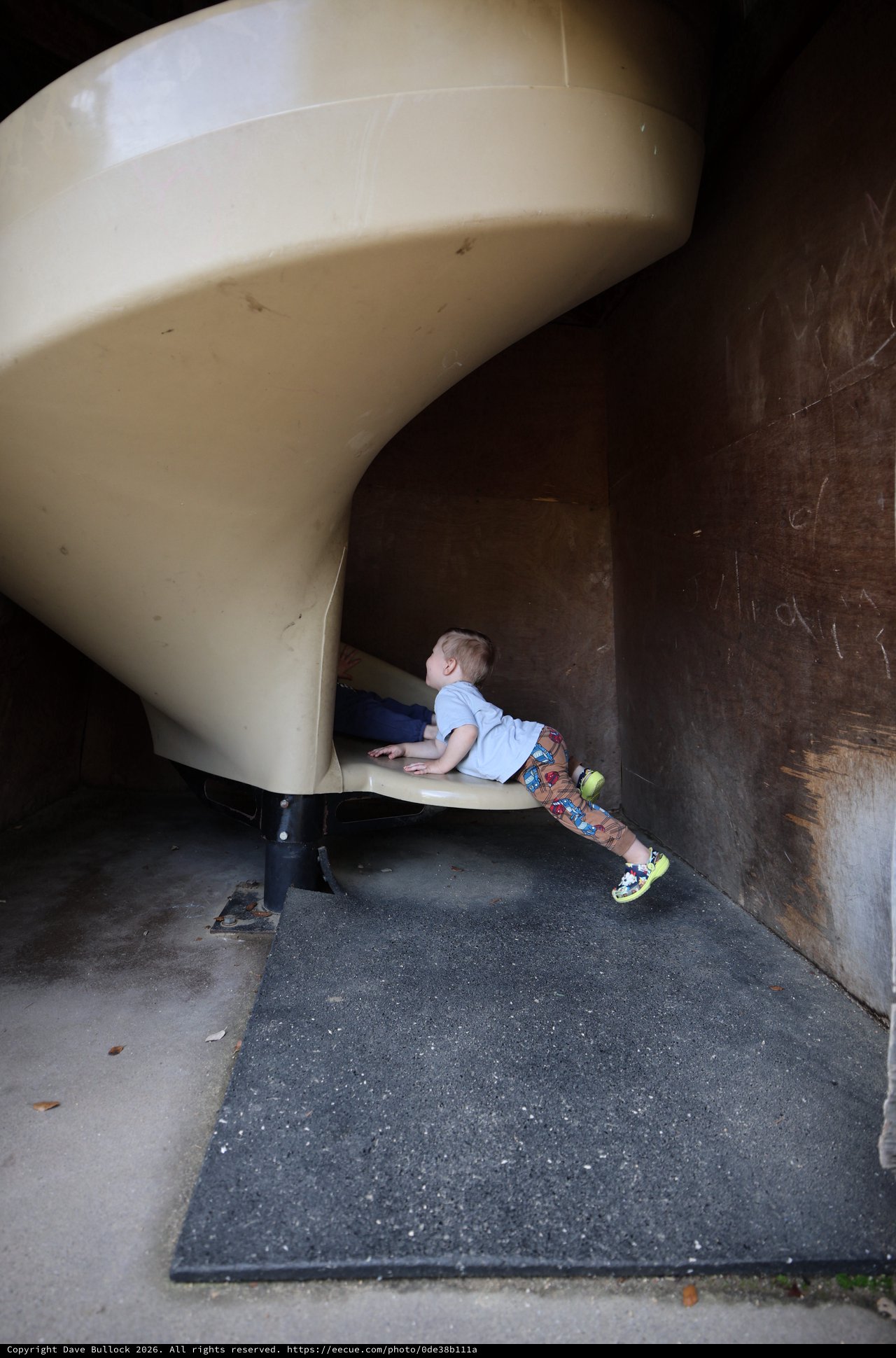 Child Exploring Playground Slide Tunnel Structure