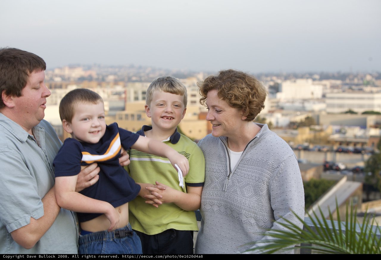 Family Portrait on Urban Rooftop Overlooking City