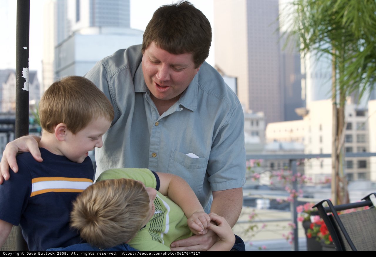 Father Bonding with Two Young Boys Outdoors