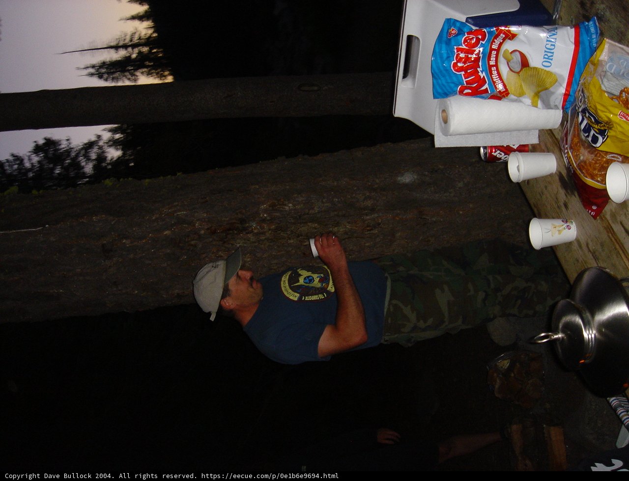 Man enjoying a drink and snacks at the table