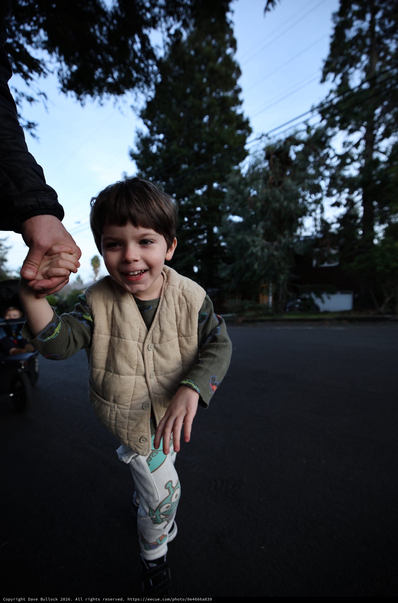 Joyful Child Holding Parent's Hand at Dusk