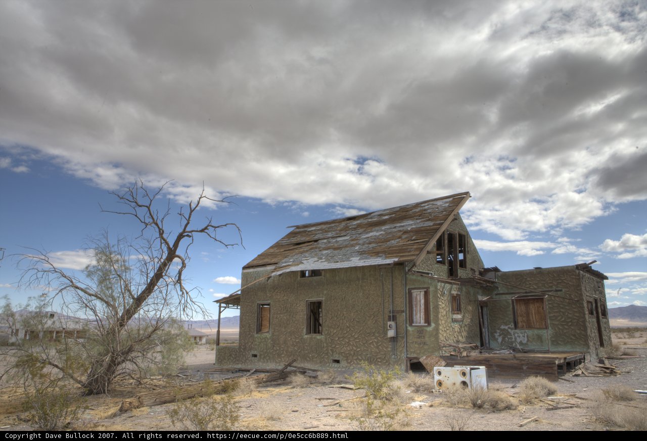 Deserted Hut under a Cloudy Sky