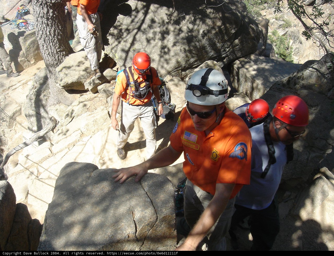 Climbing the Rock Wall in Orange Shirts
