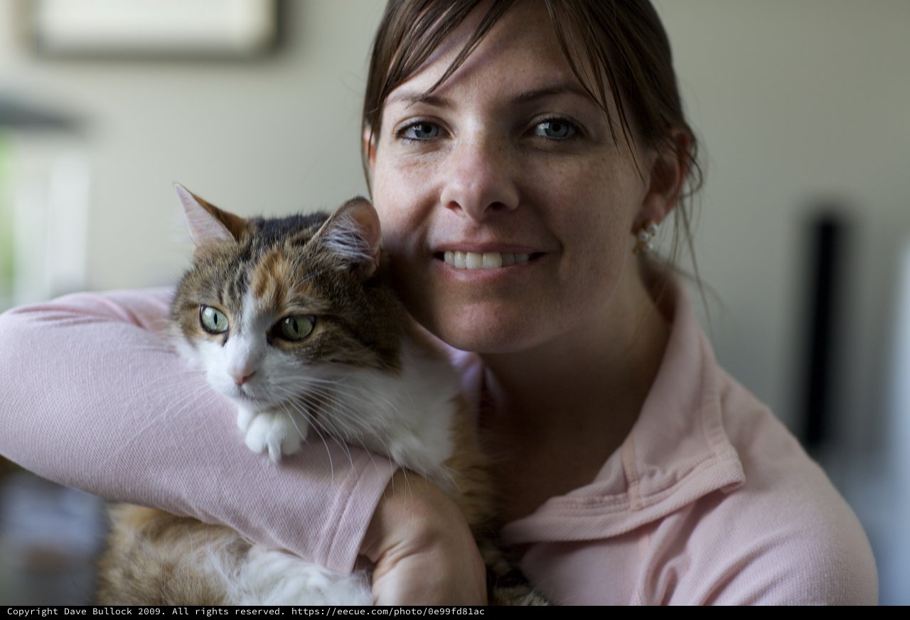 Woman and Her Calico Cat Share a Tender Moment