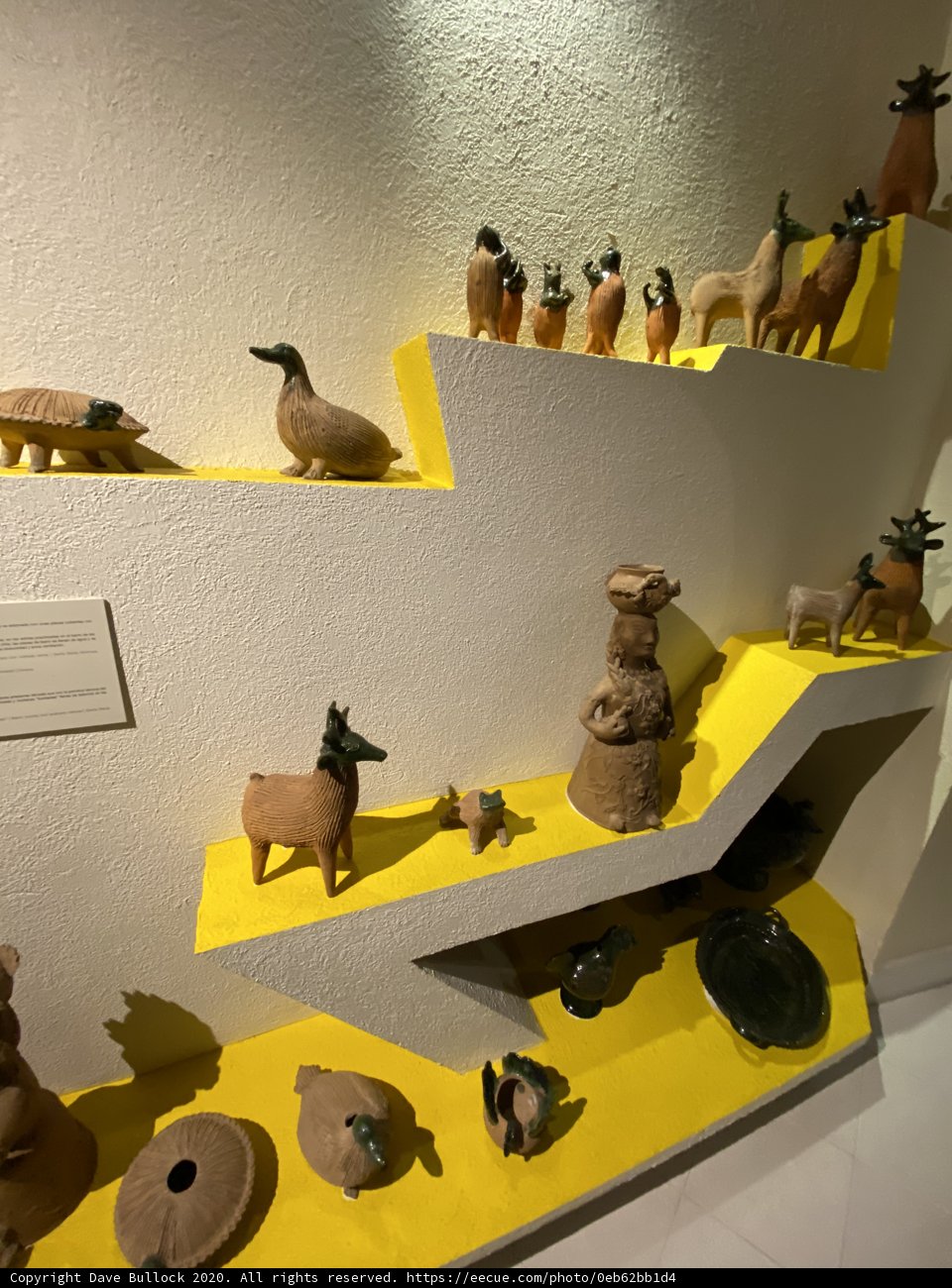 Clay Figurines and Animals on Yellow Shelf