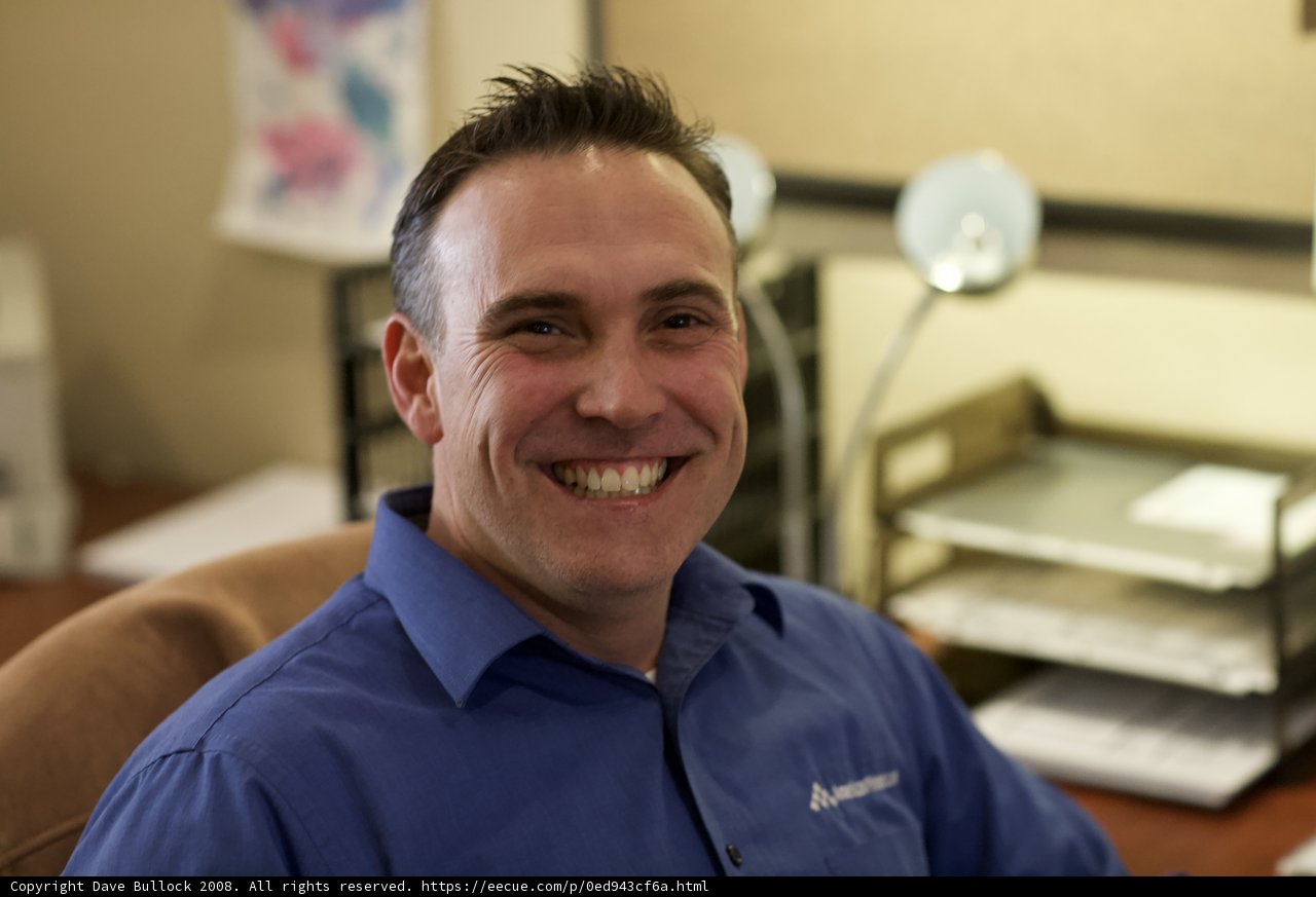 Smiling Man in Blue Shirt