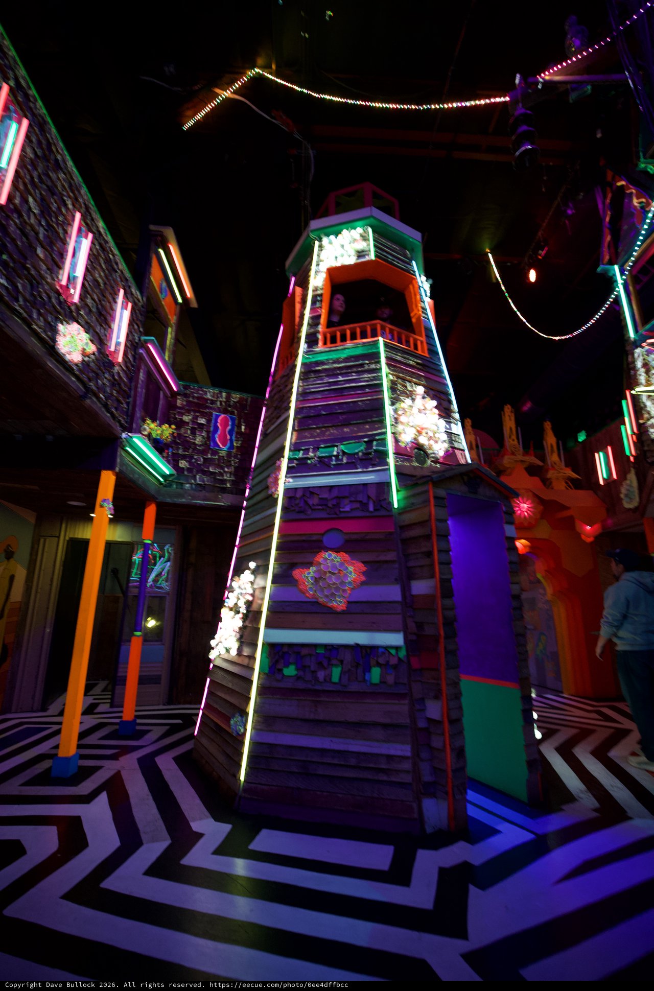 Vibrant Neon Tower Installation in Immersive Art Space