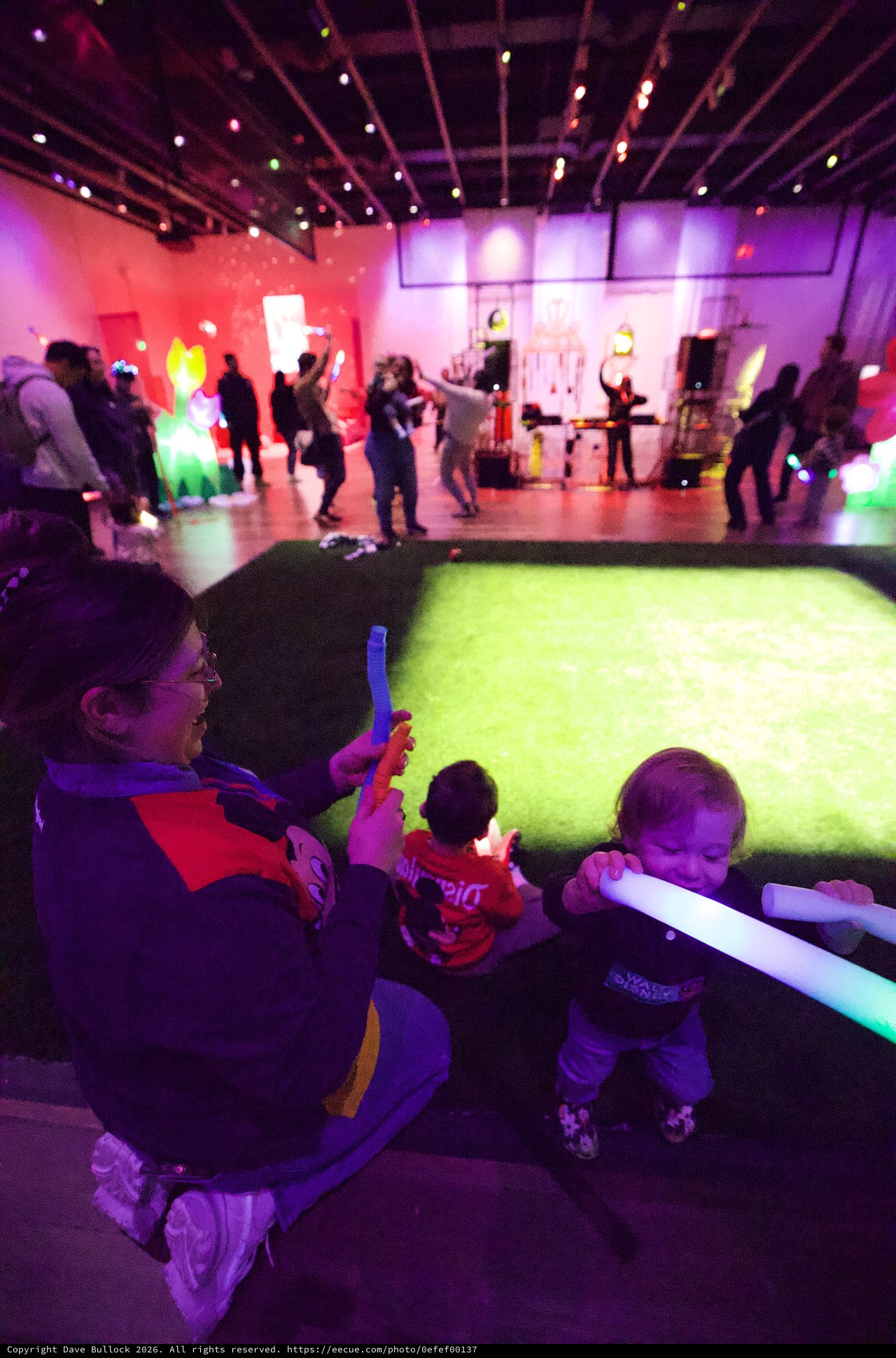 Children Playing with Glow Sticks at Baby Rave Event