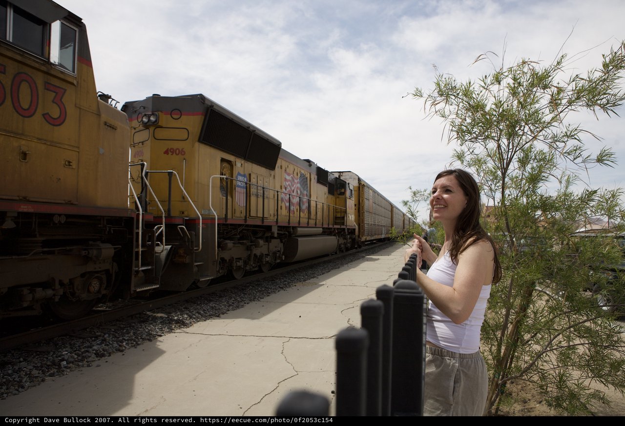 Woman Smiles as Union Pacific Freight Train Passes