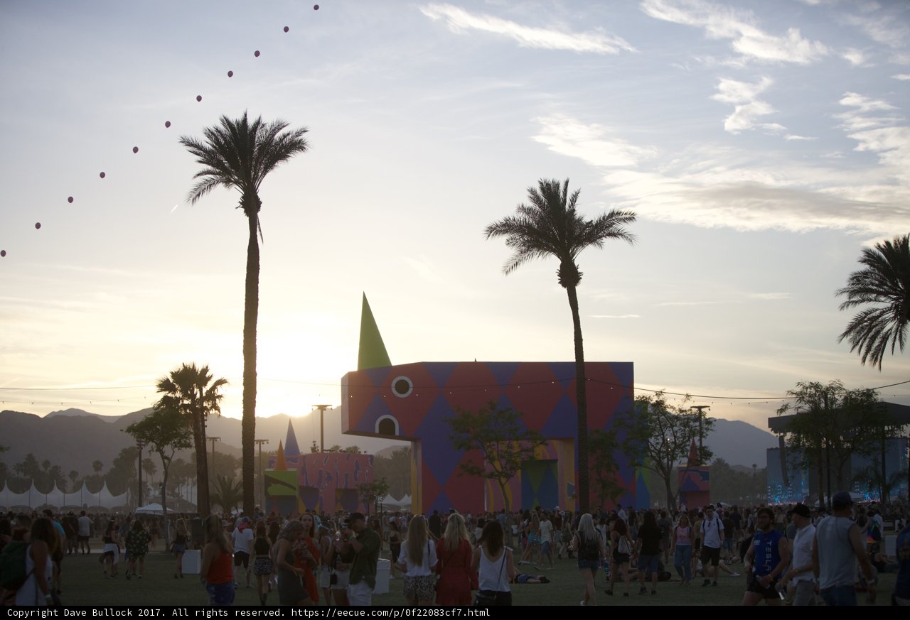Summer Crowd at Colorful Building Among Palm Trees
