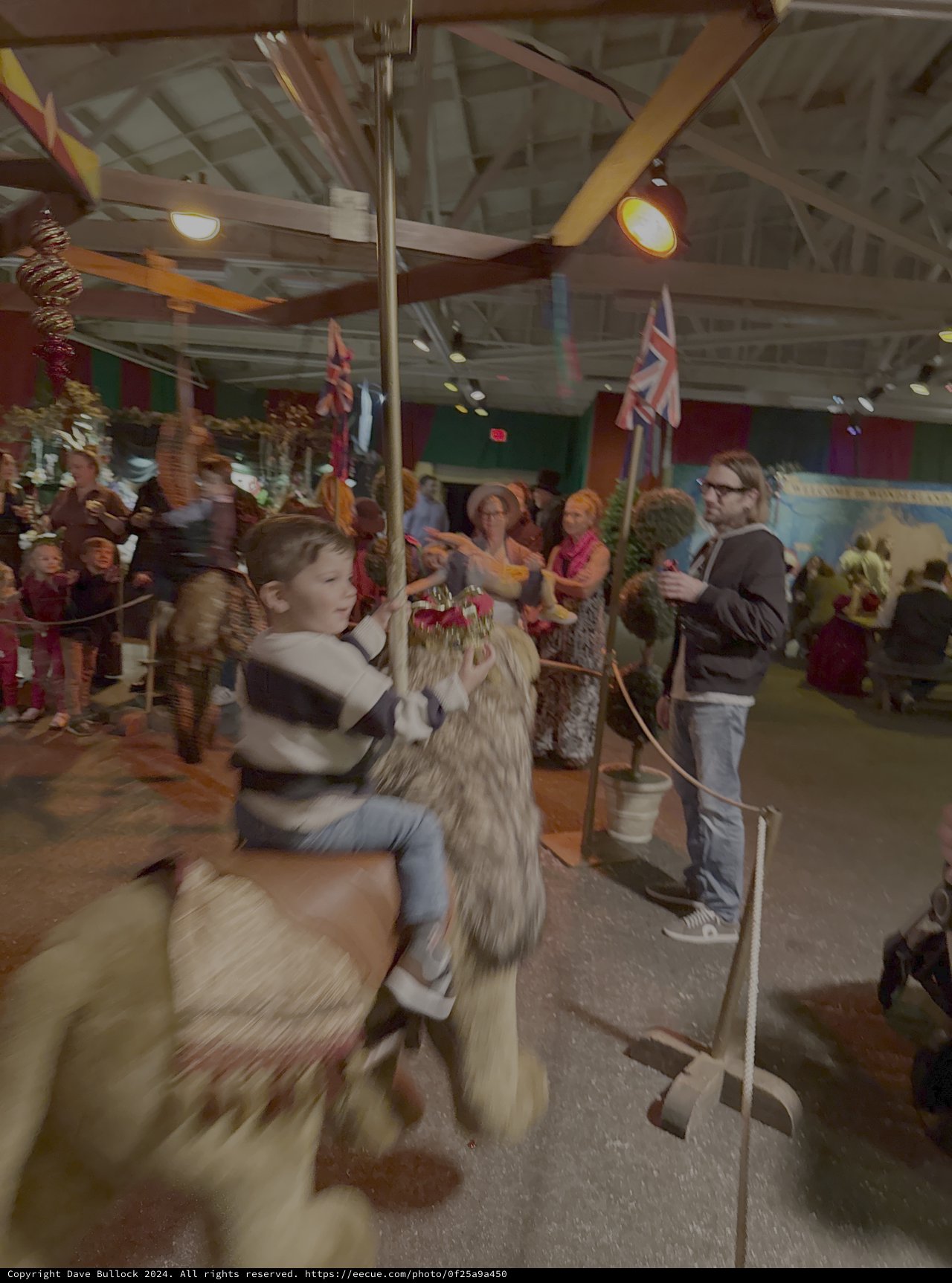Children Enjoying Carousel Ride at Indoor Fair