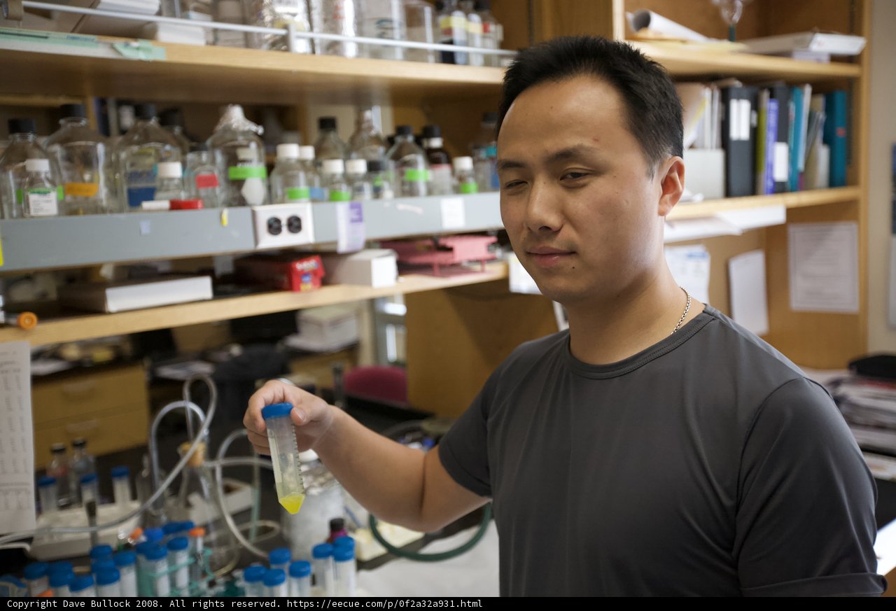 Scientist with a bottle of liquid in the UCLA nanomachines lab