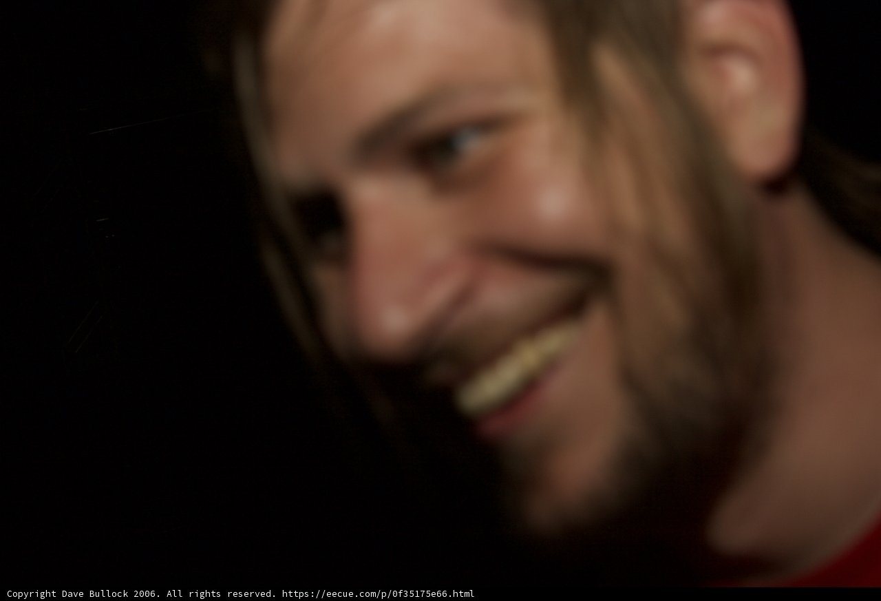 Long-haired Man Smiling in the Dark
