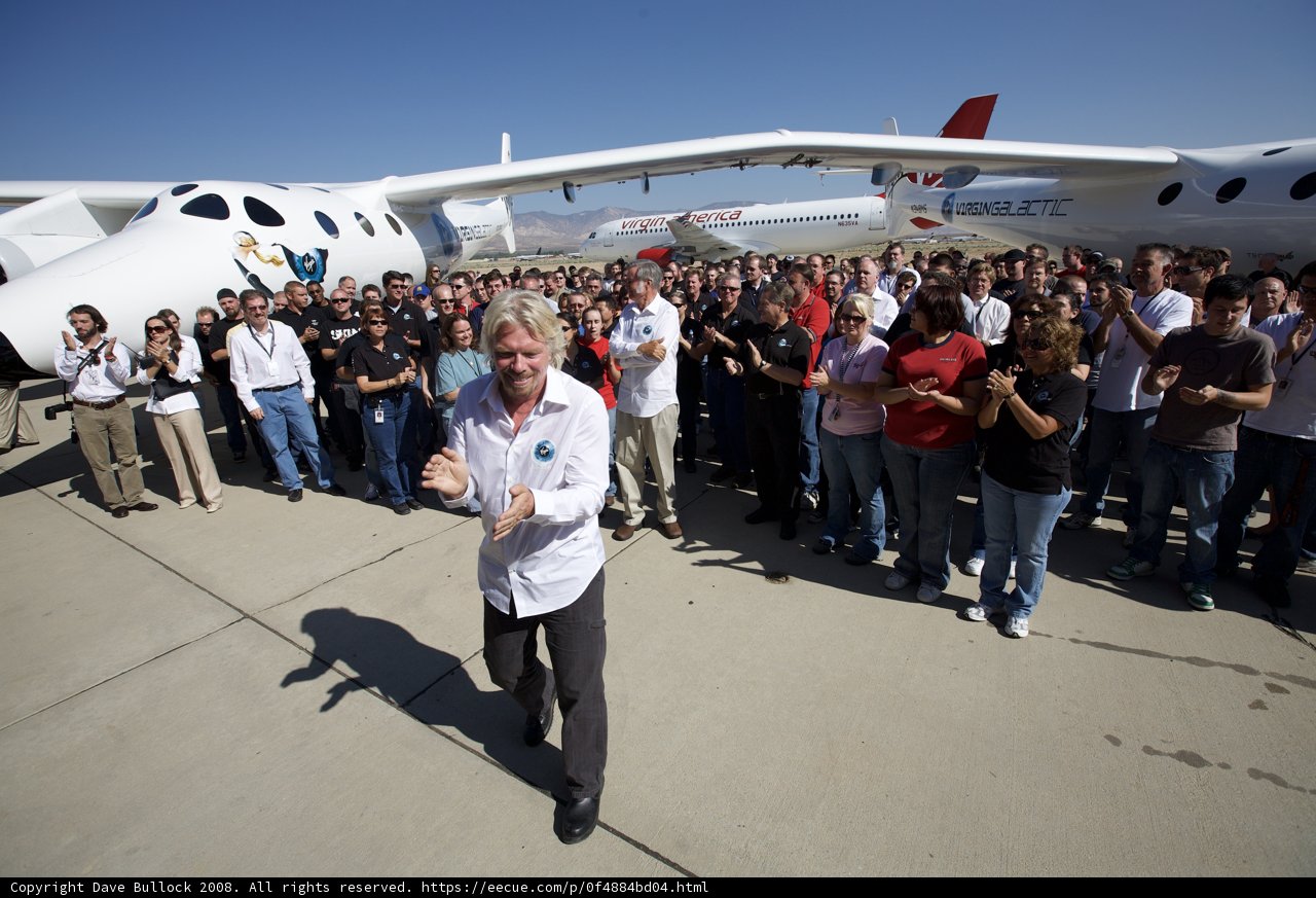 Richard Branson Stands Among the Crowd at Airfield