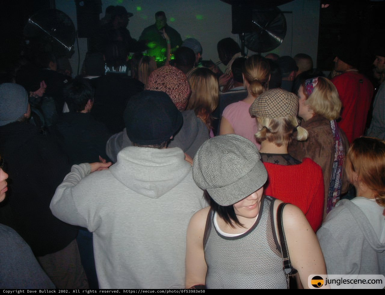Hat-wearing man among the party crowd