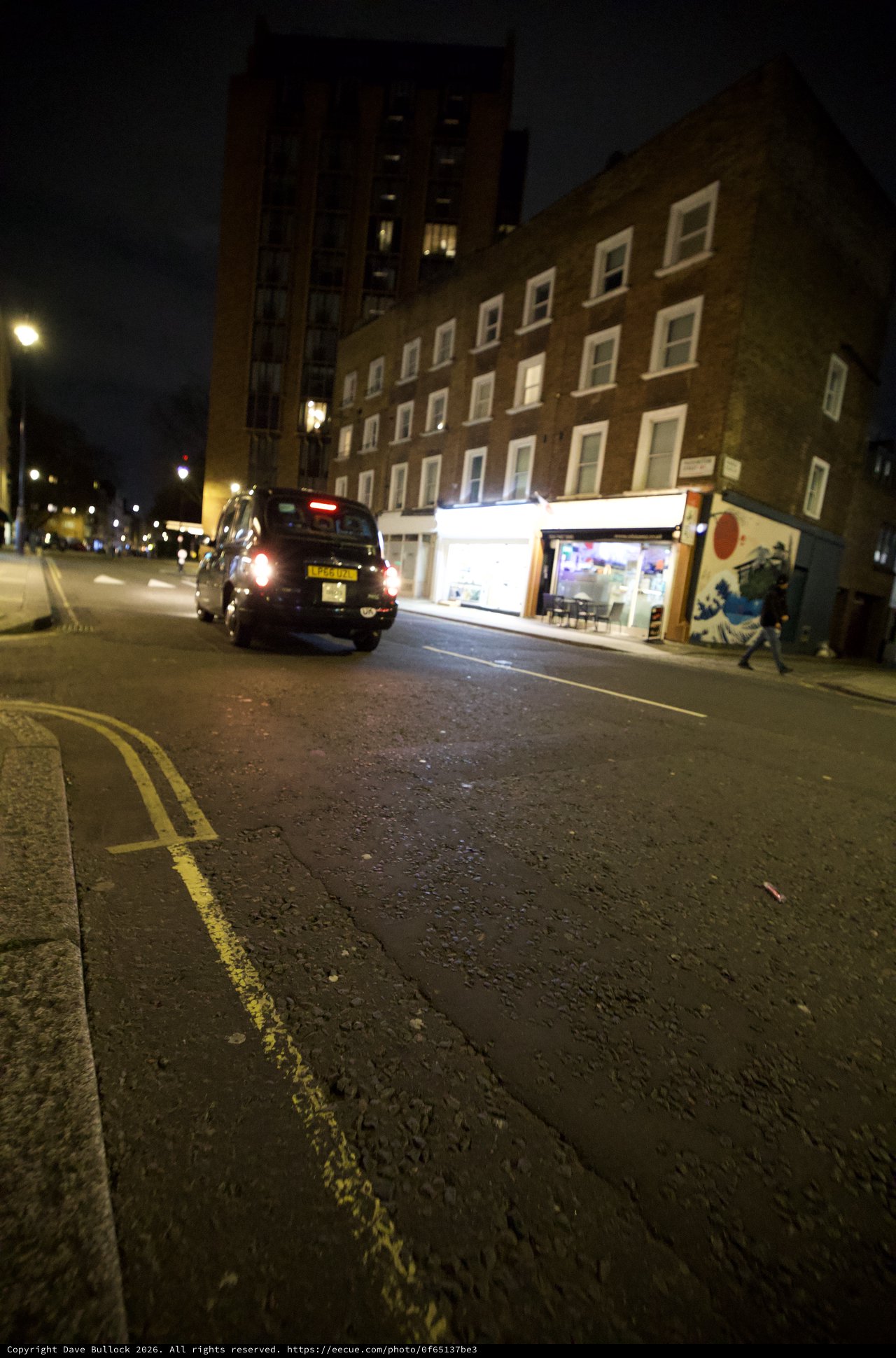 London Black Cab on Rain-Slicked Evening Street