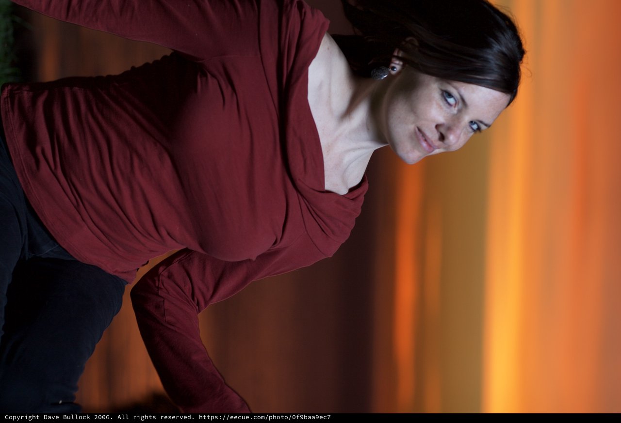 Woman in Red Gazes Skyward at Fiery Sunset