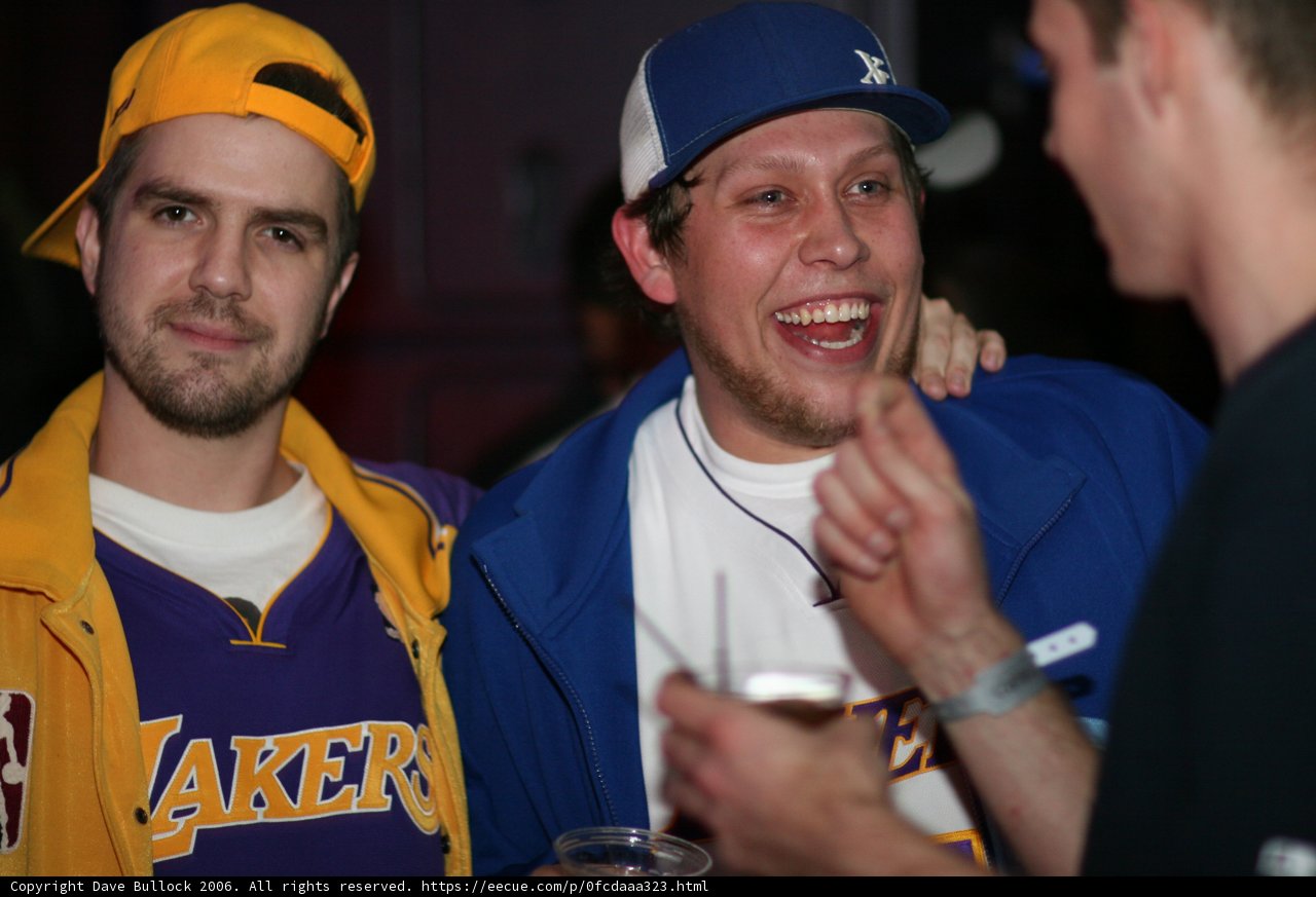Two Men Share a Laugh Over Drinks