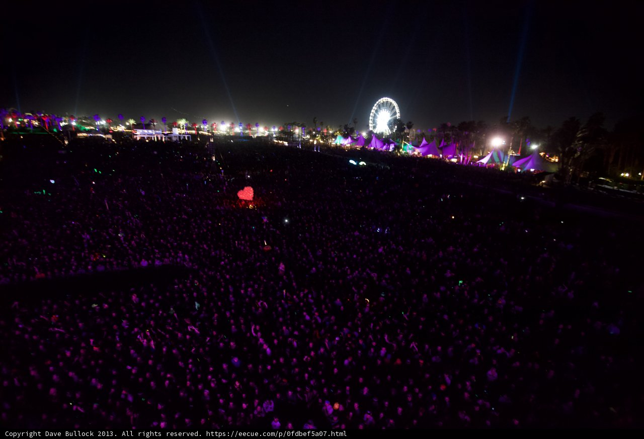 Nightlife in the Metropolis: Coachella Concertgoers bask under a Ferris Wheel