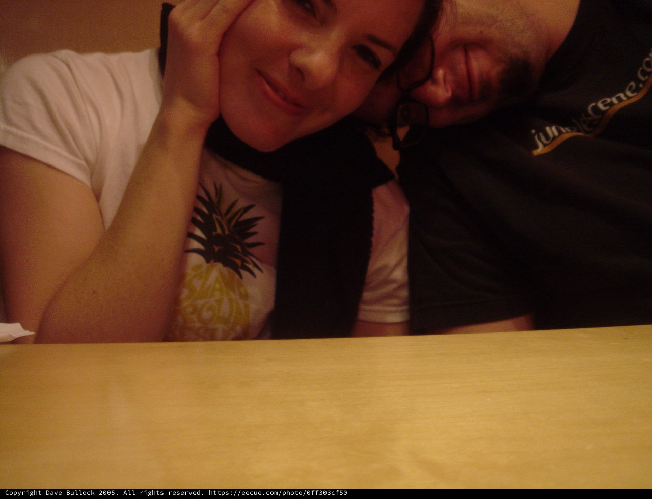 Couple Leaning Together at Table Late Night