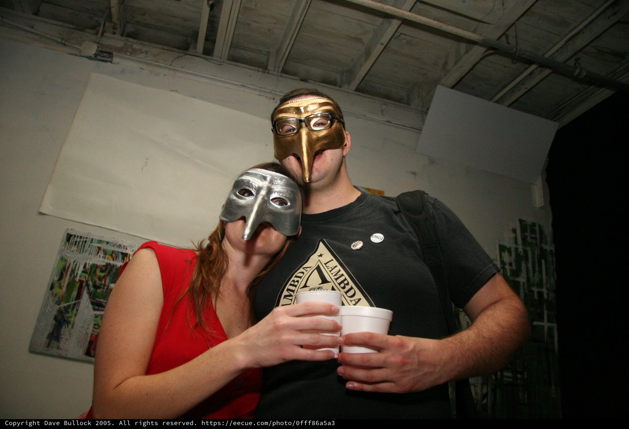 Masquerade Party Couple in Gold and Silver Masks