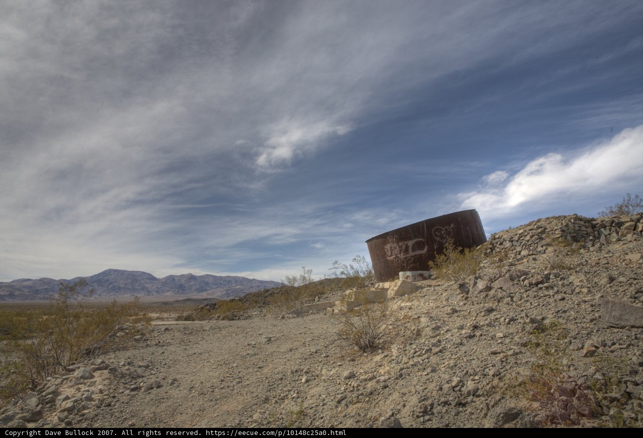 Rusty Water Tank on Rocky Hillside