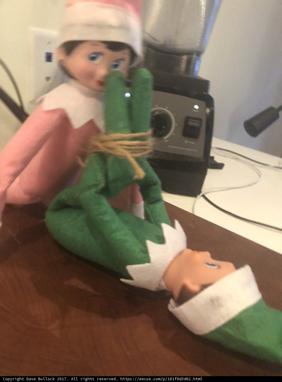 Elf holding a toy doll