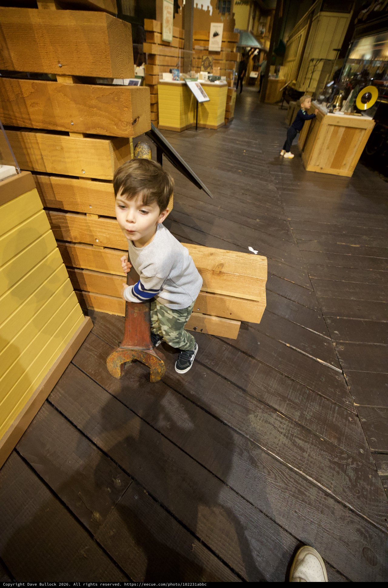 Young Boy Exploring Interactive Wood Construction Museum Exhibit