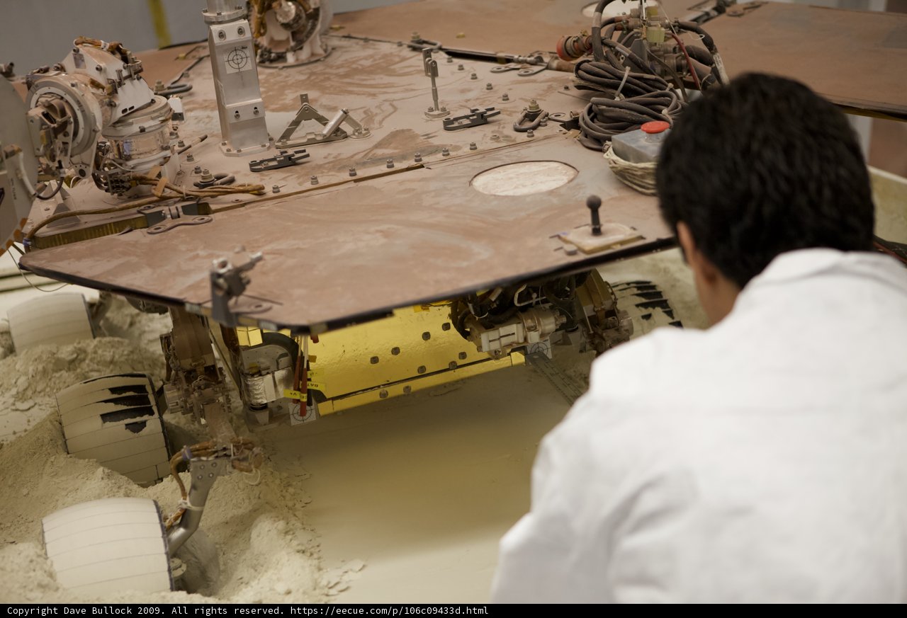 Factory man inspecting military vehicle