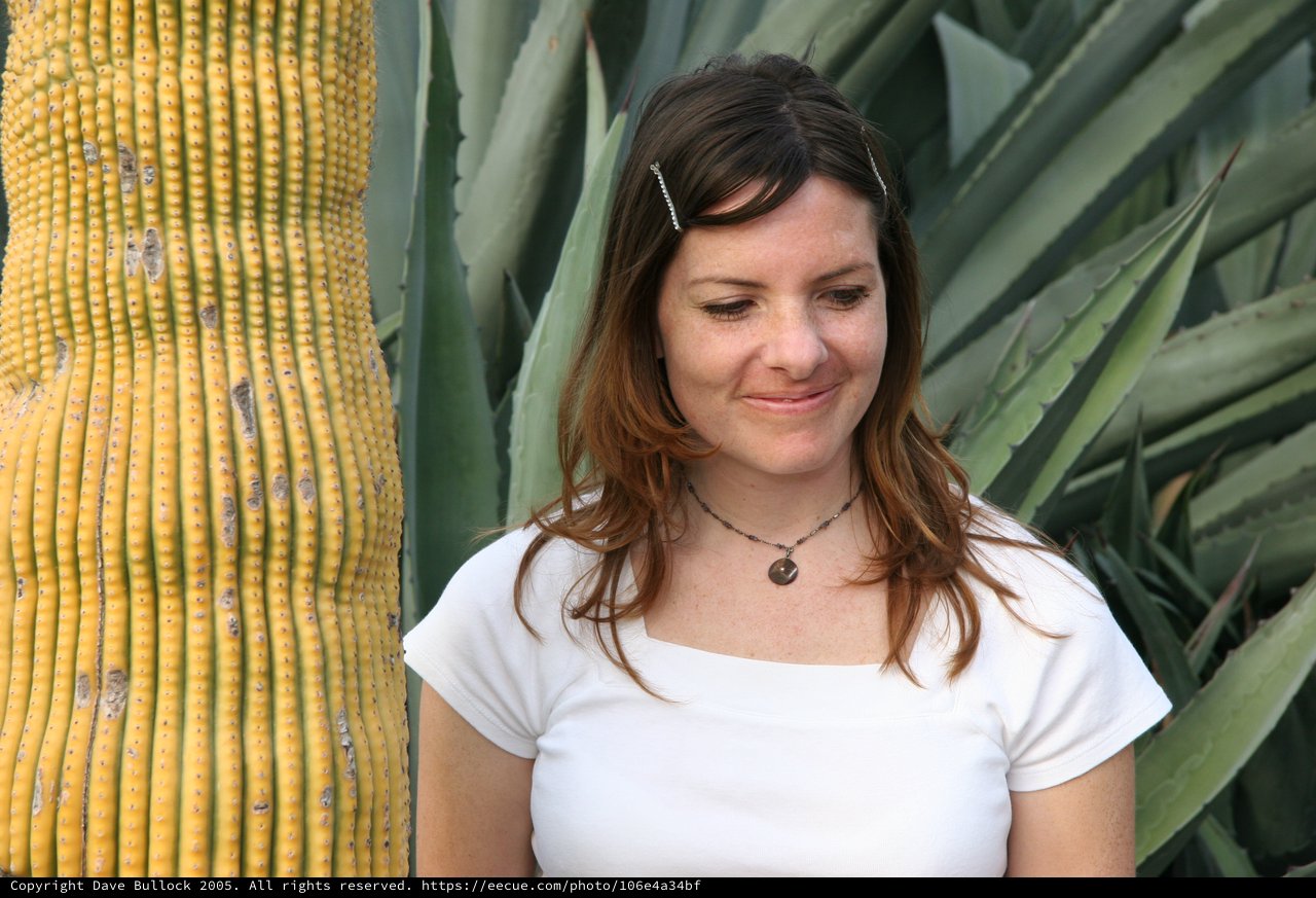 Woman Smiling Beside Desert Cactus and Agave