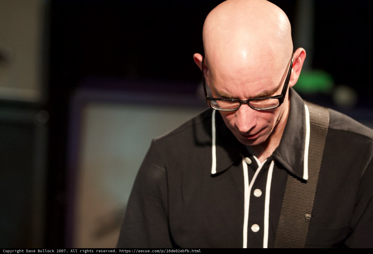 Bald Man Rocks Out on Electric Guitar