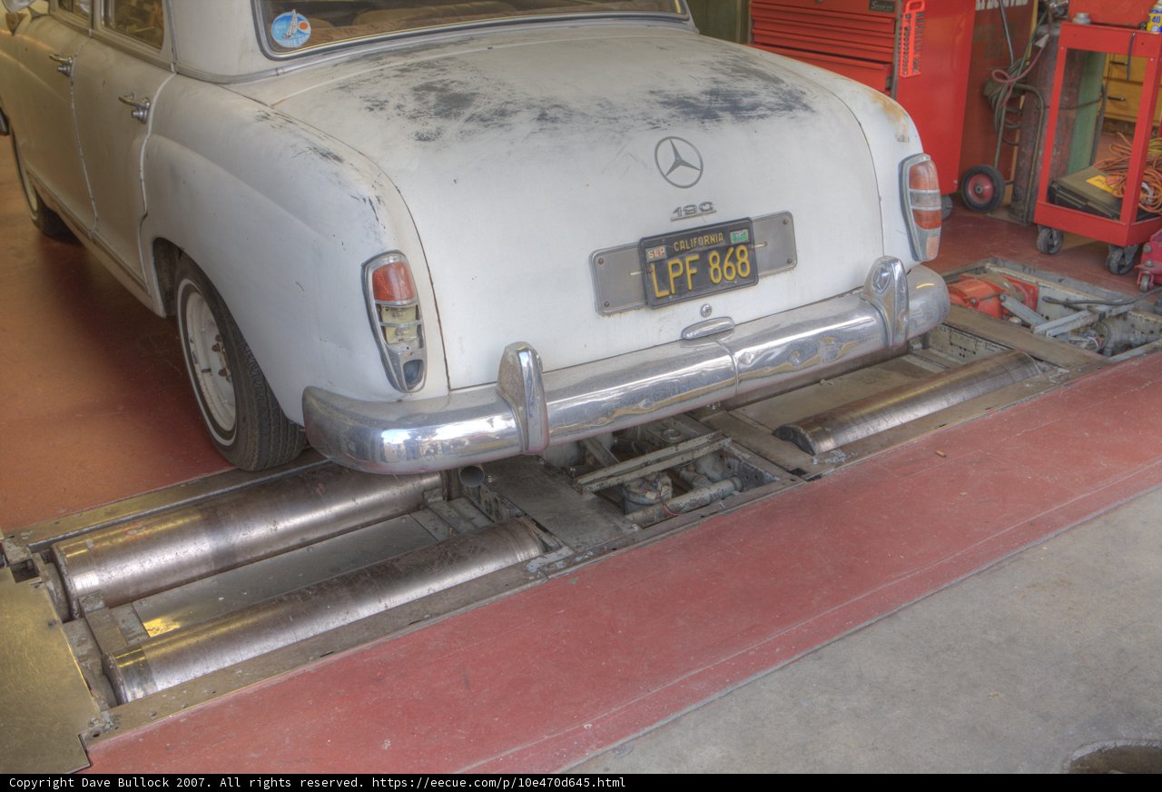 Mechanic working on a white sports car
