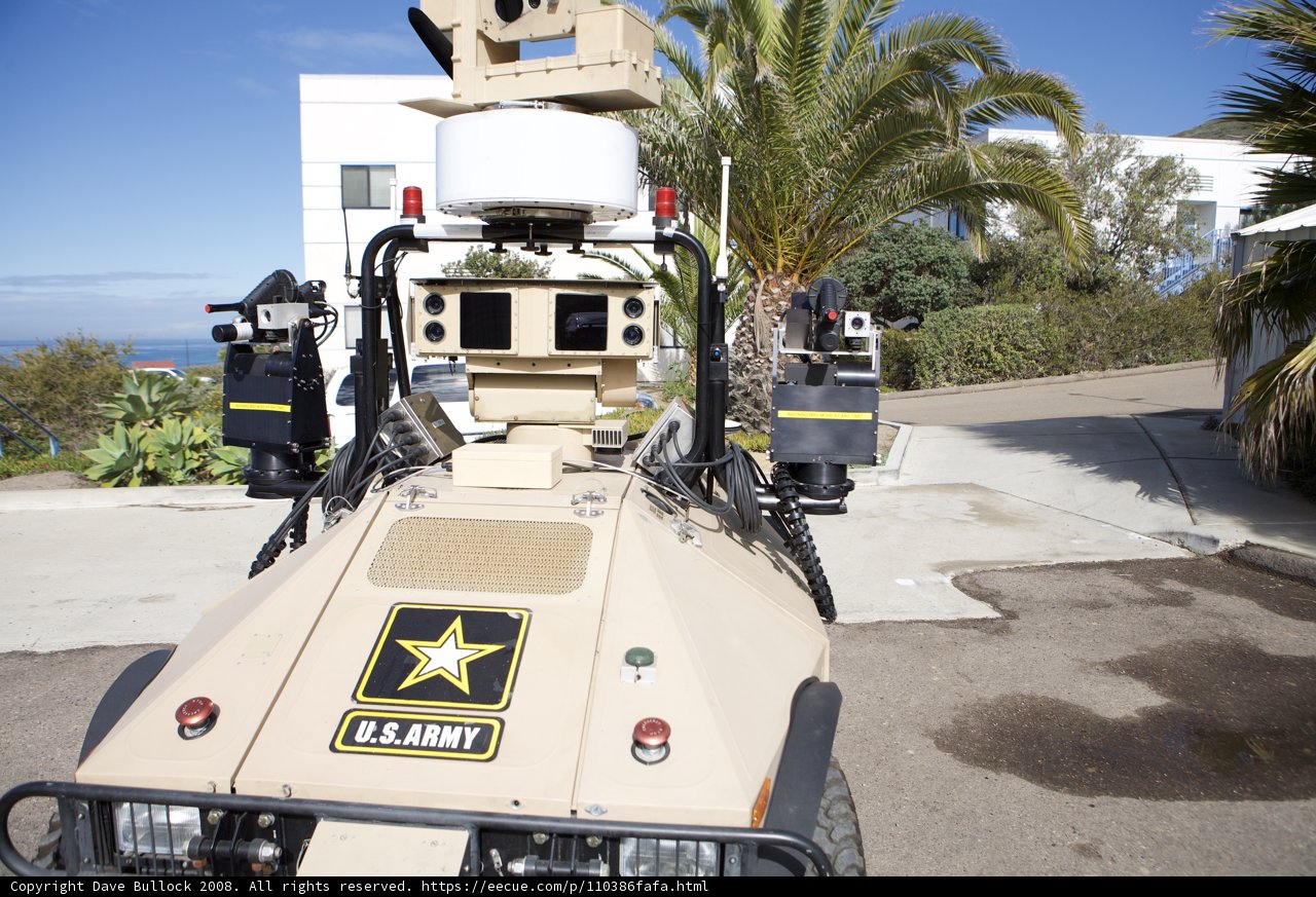 Military Vehicle with Camera in Palm Tree Surroundings