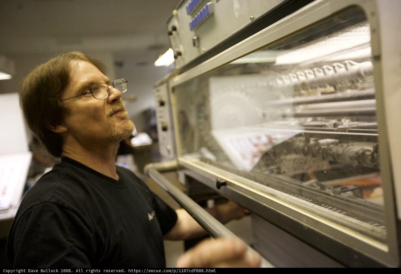 Man Inspecting Optical Equipment