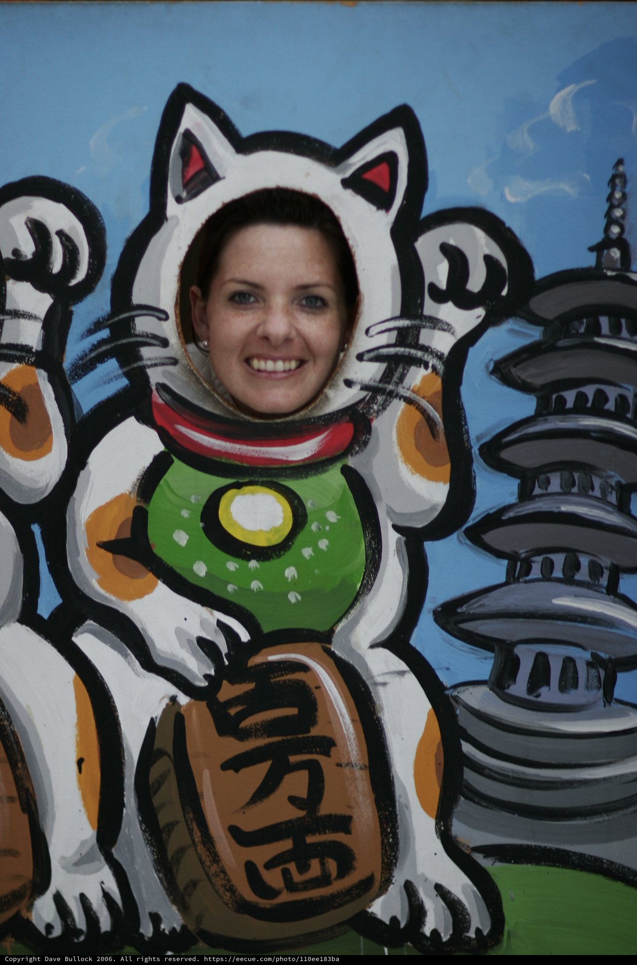 Woman Posing as Maneki-neko Lucky Cat Cutout