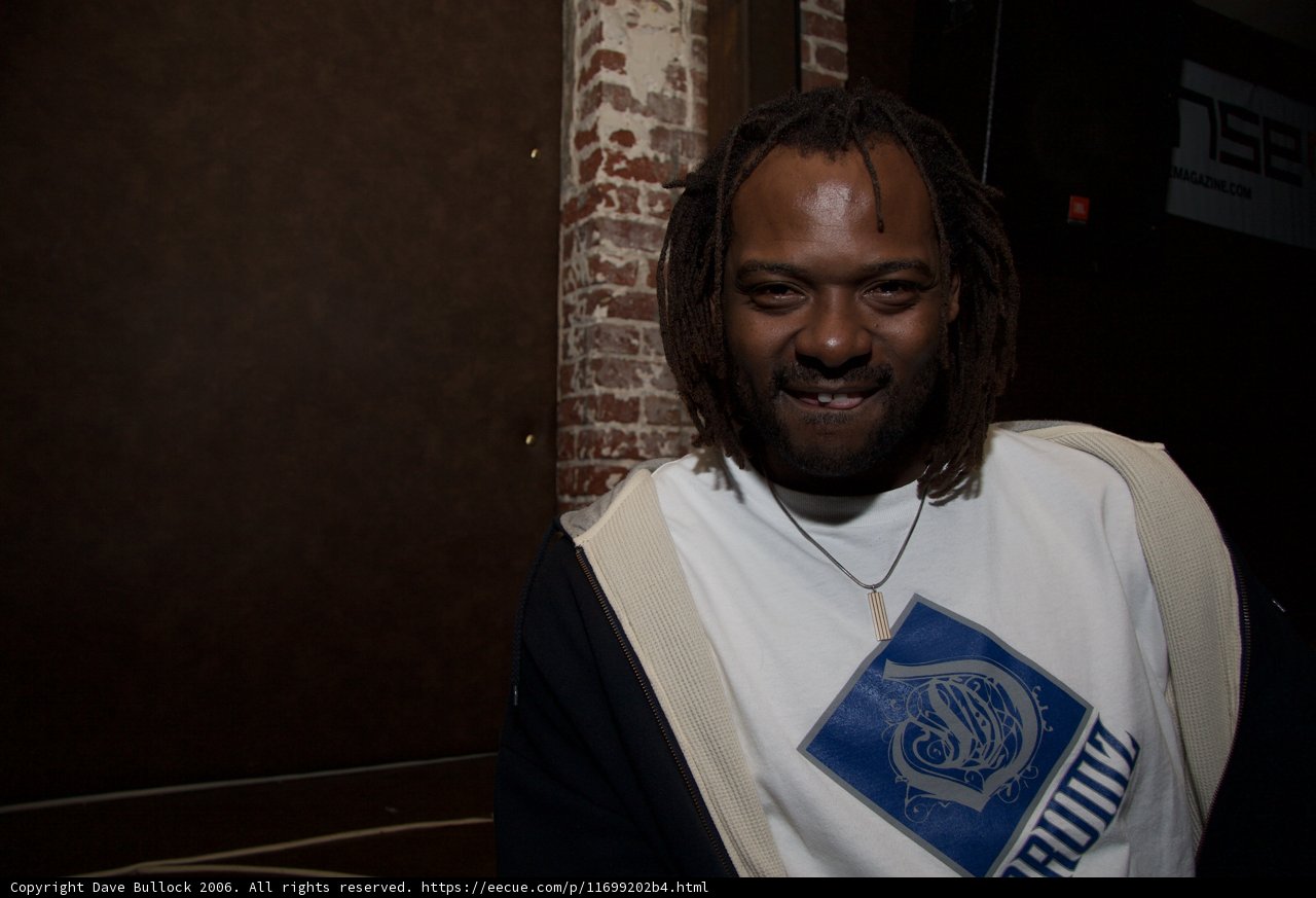 Portrait of James M in White T-Shirt and Dreadlocks