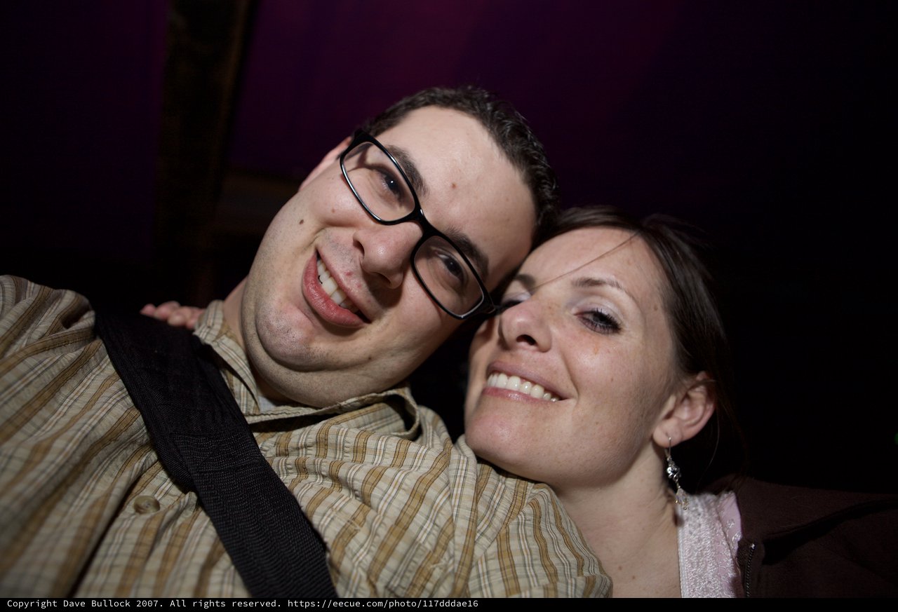 Smiling Couple Poses Together at Nighttime Event