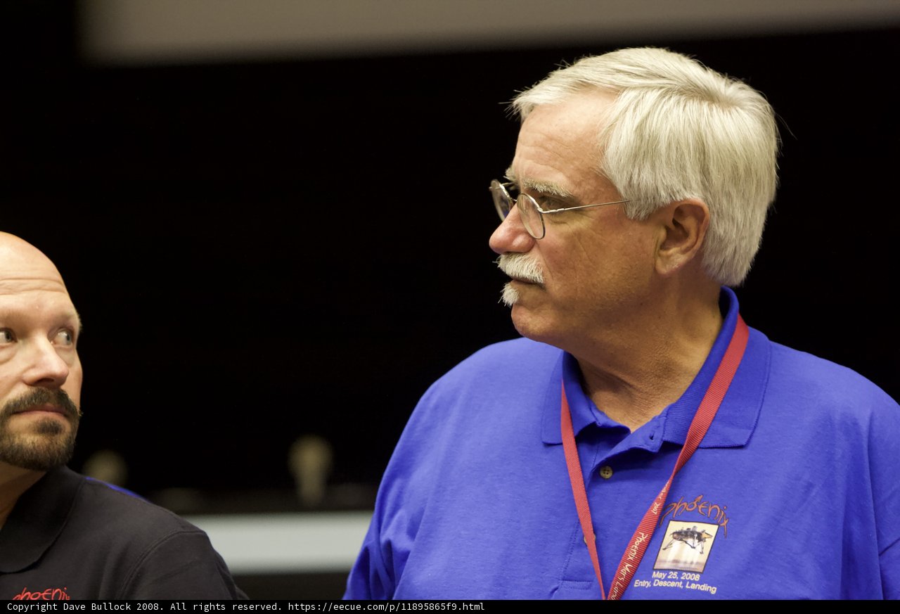 Two Men in Blue Shirts Having a Conversation