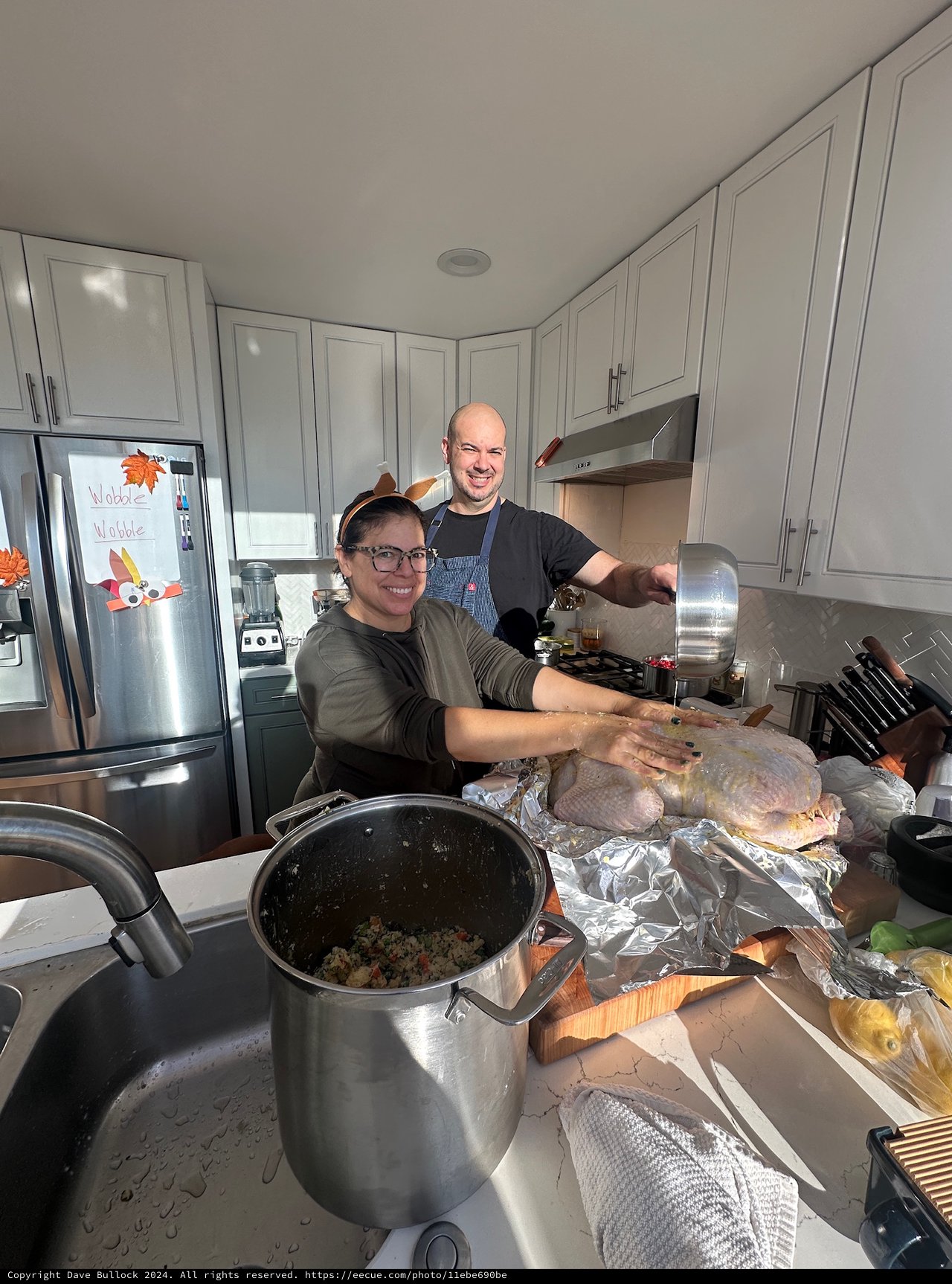 Couple Preparing Thanksgiving Turkey in Modern Kitchen