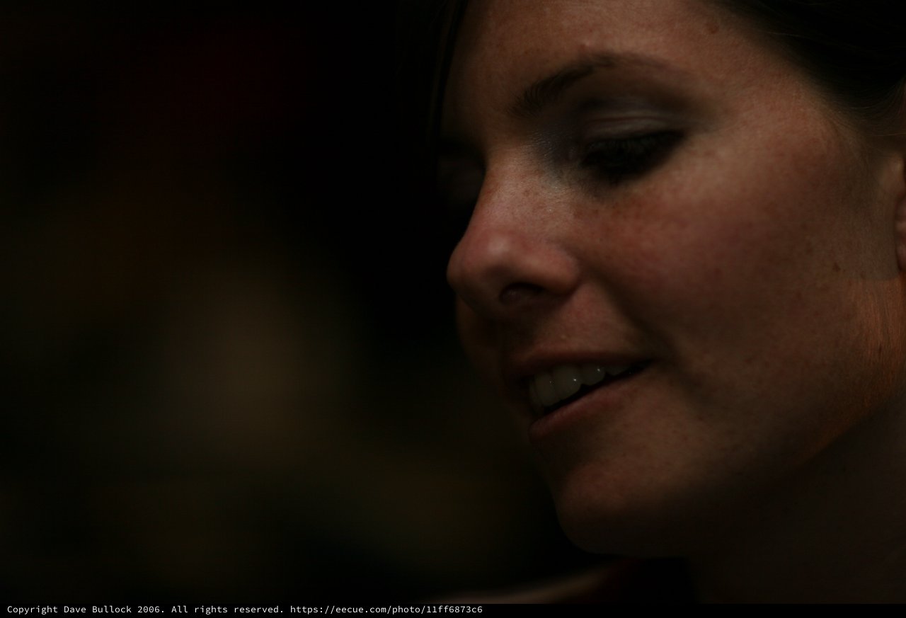 Penelope's Quiet Smile in Dramatic Low Light