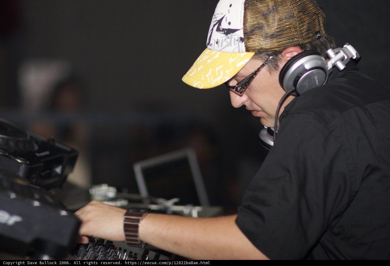 Black Shirted Man with Baseball Cap and Headphones