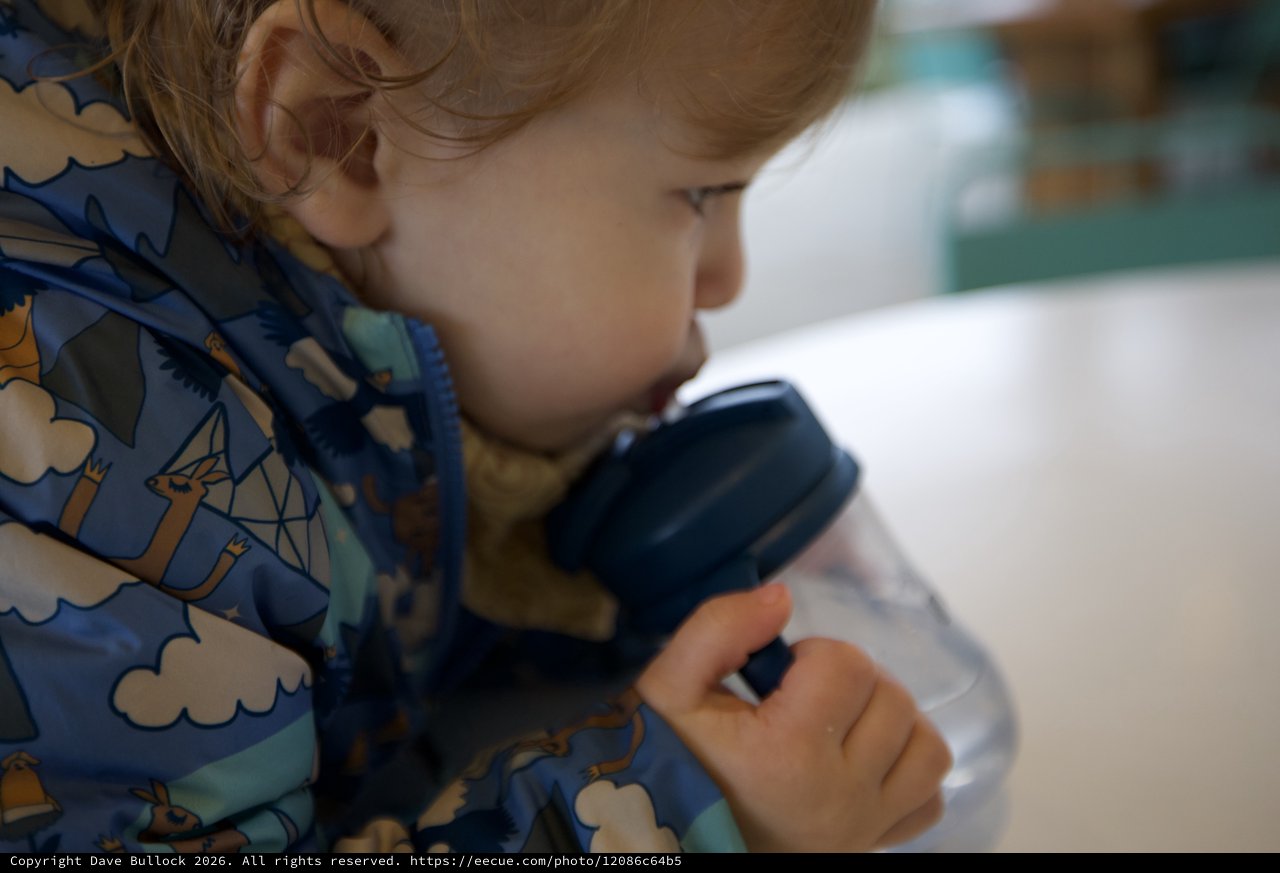 Young Child Peering Through Magnifying Glass in Wonder