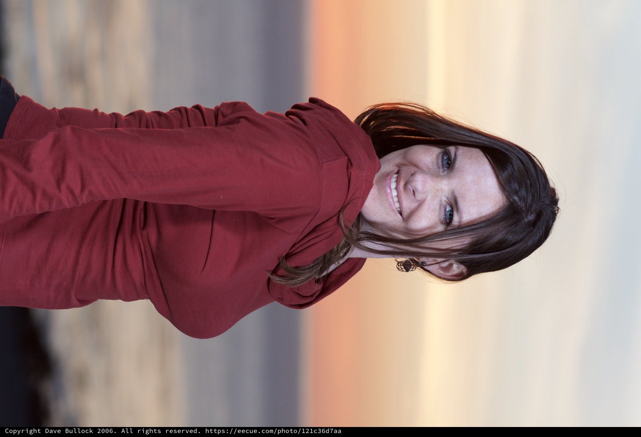 Smiling Woman at Coastal Sunset in Crimson Top