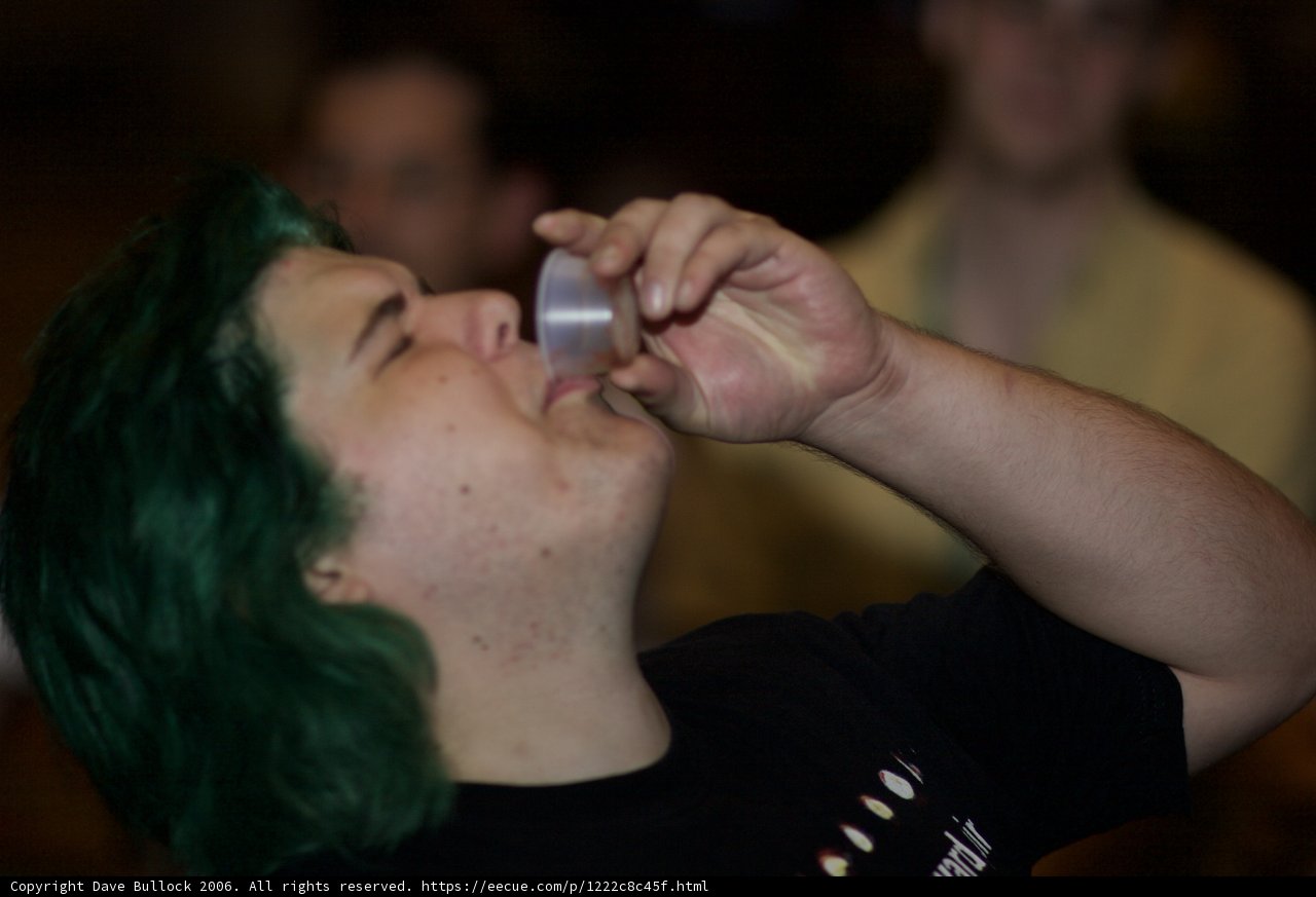 Green-Haired Man Sipping from a Tin Cup