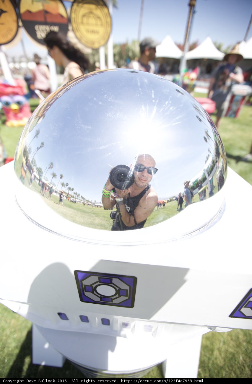 Reflections of a Sunglass-Wearing Man in a Metal Sphere