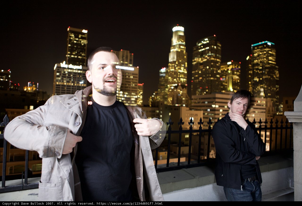Urban Night Skyline with Two Men in Coats