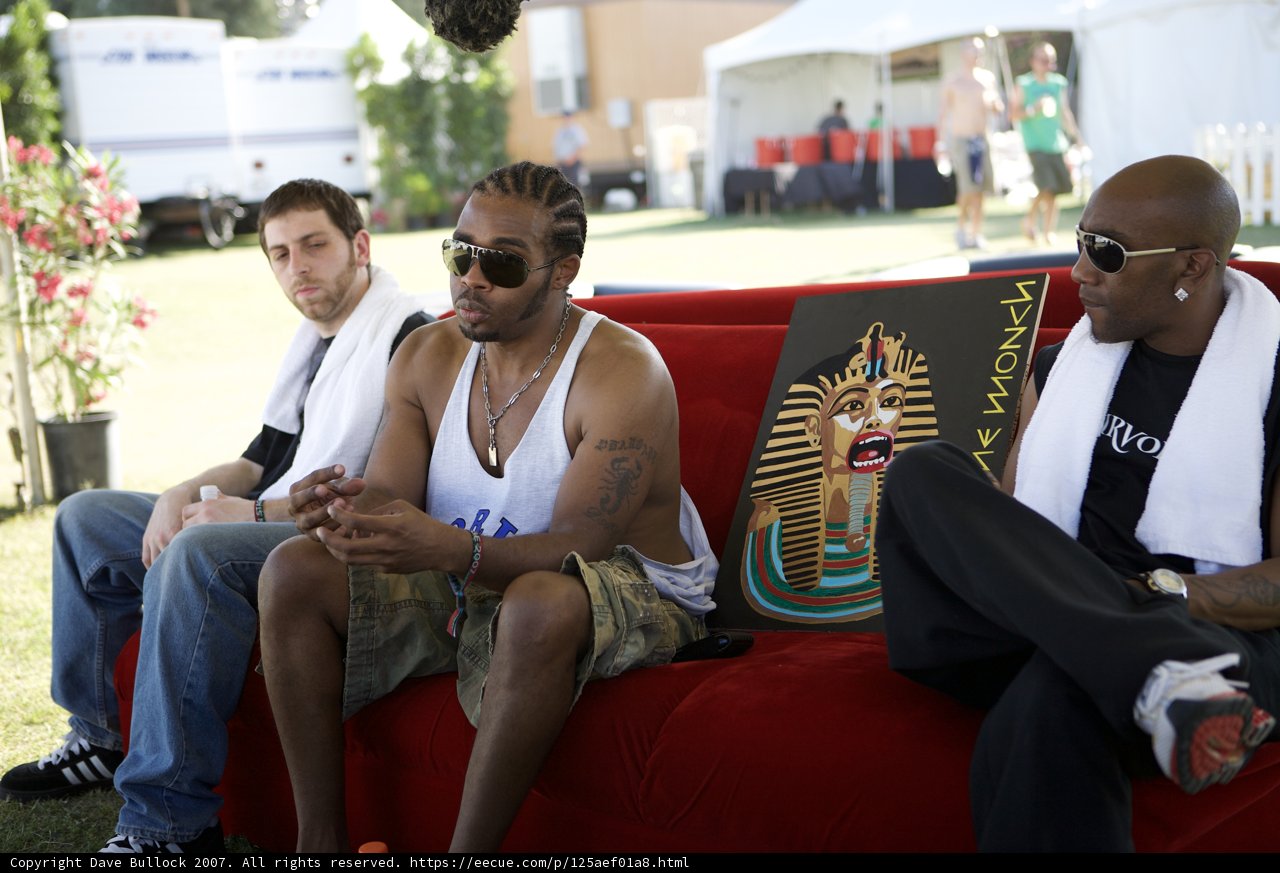Man Relaxes on Vibrant Red Couch at Coachella