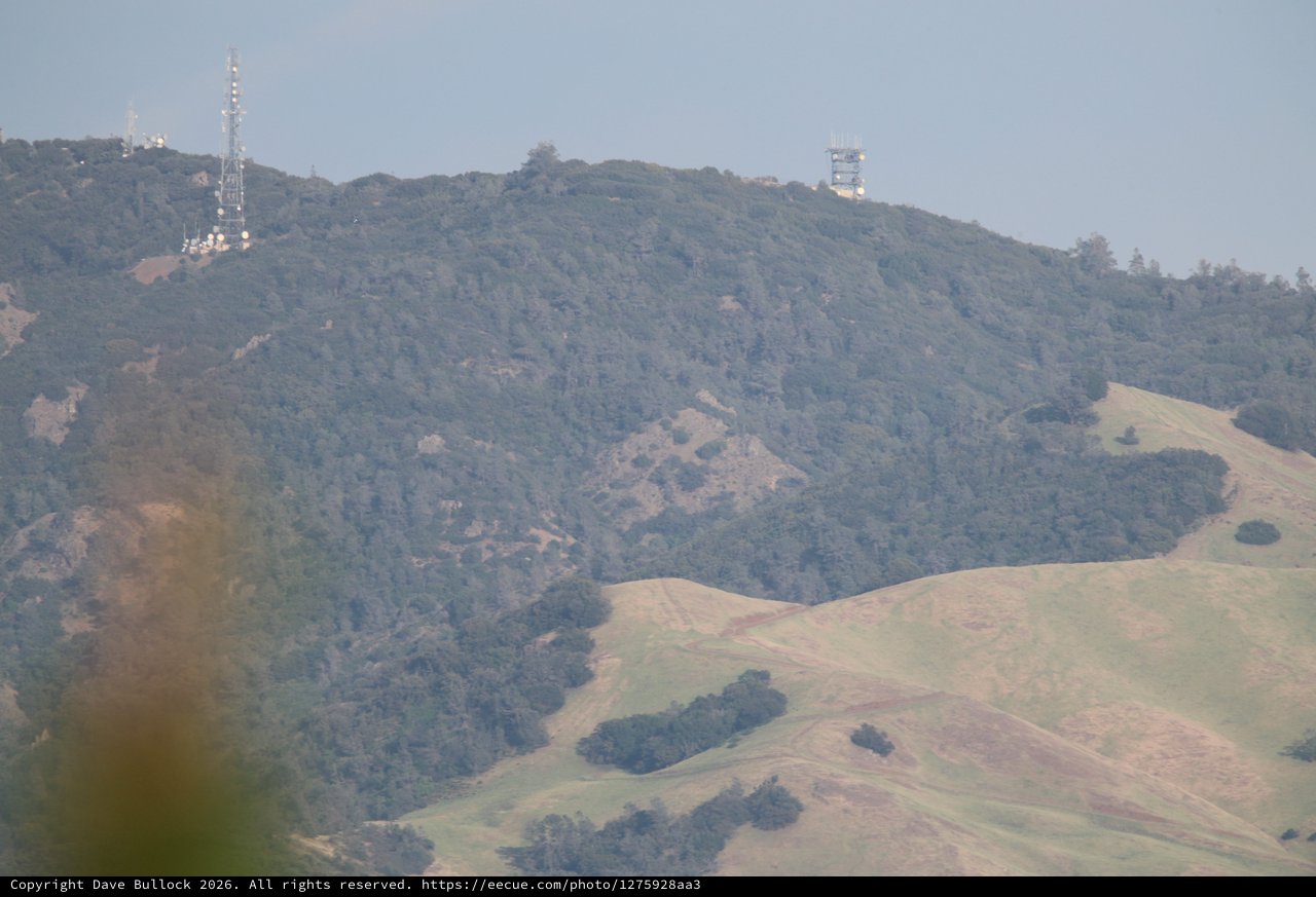Rolling Hills and Communication Towers in Hazy Landscape