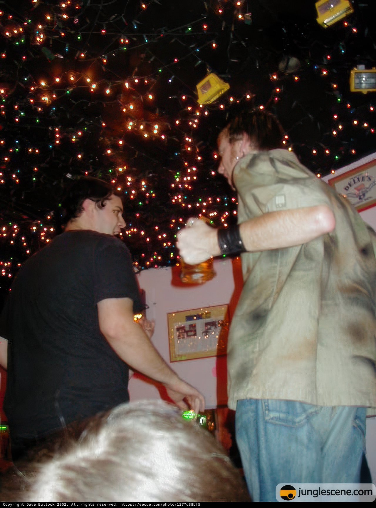 Two Men Enjoying Beers with Christmas Decorations